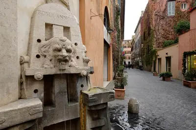 a statue of a lion on the side of a building at Margutta Mews in Rome