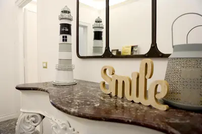 a table with a sign that reads smile next to a lighthouse at Domus Vintage in Rome