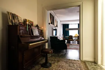 a living room with a piano and a chair at Domus Vintage in Rome