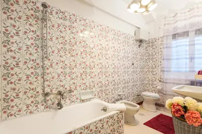 a bathroom with a tub and a toilet and a sink at Domus Vintage in Rome