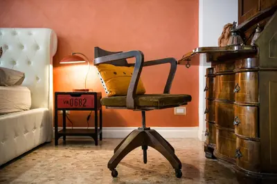 a chair with a pillow on it in a bedroom at Domus Vintage in Rome