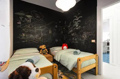 a bedroom with two beds and a wall covered in graffiti at Domus Vintage in Rome