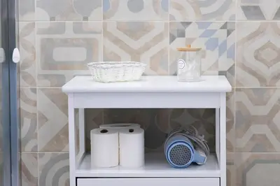 a white table with two rolls of toilet paper on it at B&B Domus Aurea in Rome