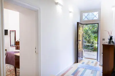 a hallway with a door leading to a bedroom at B&B Domus Aurea in Rome