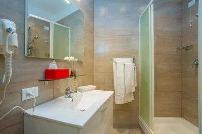 a bathroom with a sink and a shower at BQ House Castello Luxury Rooms in Rome