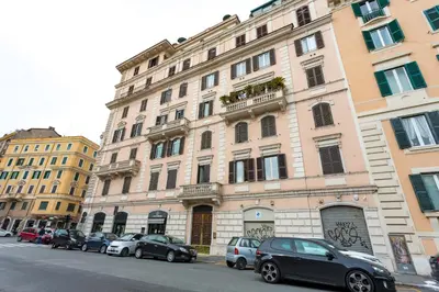 a large building with cars parked in front of it at BQ House Castello Luxury Rooms in Rome