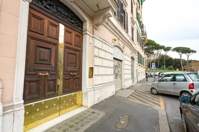 a building with a large wooden door on a street at BQ House Castello Luxury Rooms in Rome