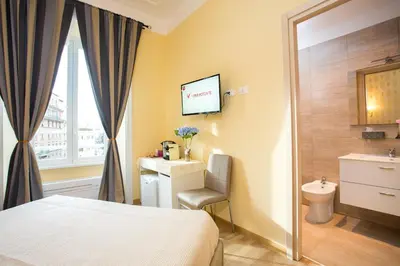 a hotel room with a bed and a toilet at BQ House Castello Luxury Rooms in Rome