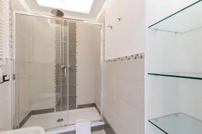 a bathroom with a shower with a glass door at Casa Vacanze Colosseum by Serena in Rome