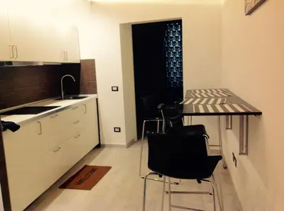 a kitchen with a table and chairs in a room at Casa Vacanze Colosseum by Serena in Rome