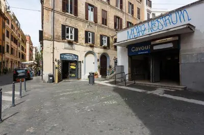an empty street in a city with buildings at Casa Vacanze Colosseum by Serena in Rome