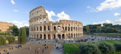 a group of people walking around the coliseum at M Empire in Rome