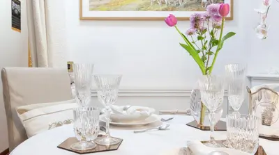 a table with glasses and a vase of flowers on it at M Empire in Rome