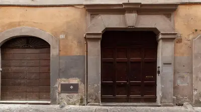 two wooden doors on the side of a building at M Empire in Rome