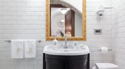a bathroom with a sink and a mirror at M Empire in Rome