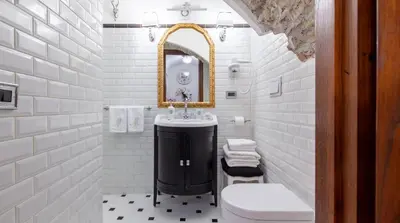 a white bathroom with a sink and a mirror at M Empire in Rome