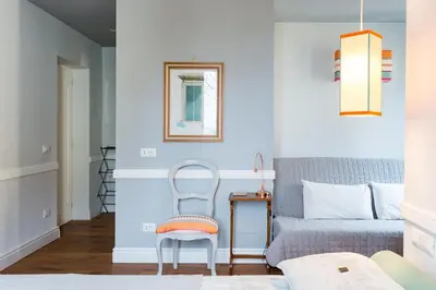 a bedroom with a bed and a chair at Guest House Poerio88 in Rome