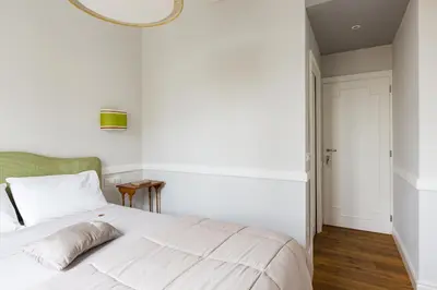 a bedroom with a white bed and a mirror at Guest House Poerio88 in Rome