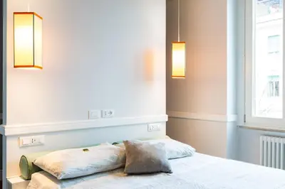 a bed with two pillows on it in a room at Guest House Poerio88 in Rome