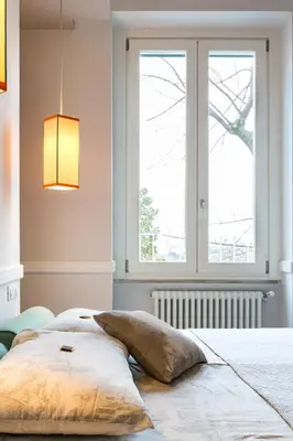 a bed in a room with a large window at Guest House Poerio88 in Rome