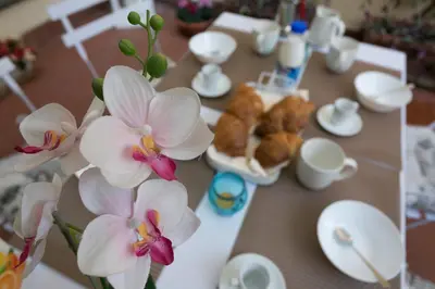 a table with white flowers in a vase on it at S.Angelo Terrace sq Navona in Rome