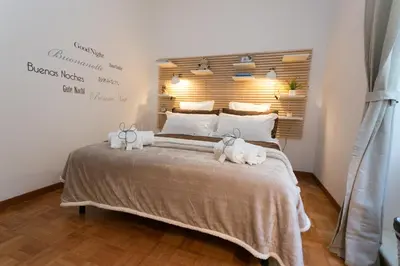 a bedroom with a bed with two animals laying on it at S.Angelo Terrace sq Navona in Rome