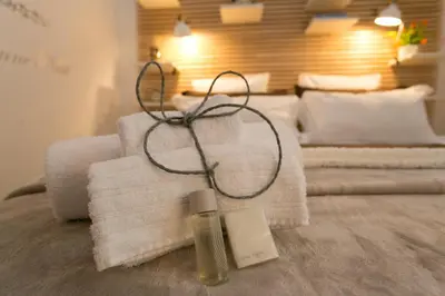 a pile of towels and a bottle of soap on a bed at S.Angelo Terrace sq Navona in Rome