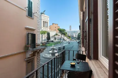 a balcony with a table and a view of a canal at Vittoriano Suite in Rome