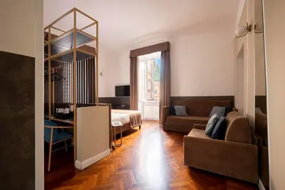 a living room with a couch and a bed at Vittoriano Suite in Rome
