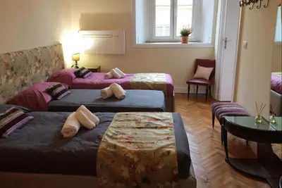 a hotel room with two beds and a table at Casa Minerva Al Pantheon in Rome
