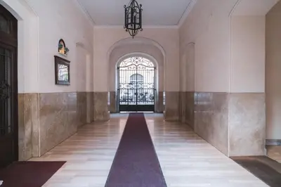an empty hallway in a building with a large window at HC - Sunny Apartment in Testaccio! in Rome