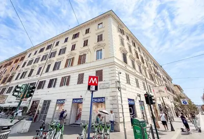a large white building with a m sign in front of it at Federici Guest House in Rome