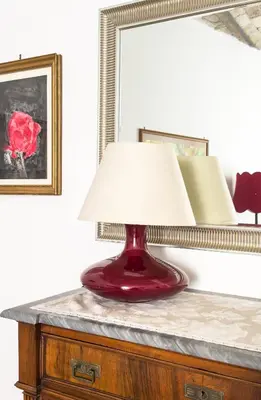 a red lamp on a dresser with a mirror at Federici Guest House in Rome