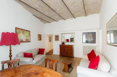 a living room with white furniture and red pillows at Federici Guest House in Rome