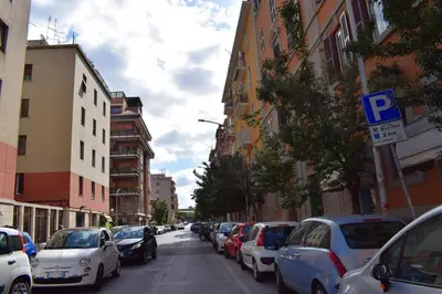 a city street filled with parked cars and buildings at I Petali Guest House in Rome