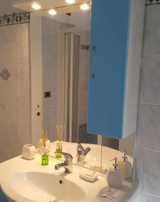 a bathroom with a sink and a mirror at I Petali Guest House in Rome