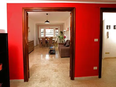 a living room with red walls and a red wall at Marina Home in Rome