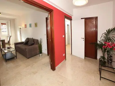 a living room with a couch and a red wall at Marina Home in Rome