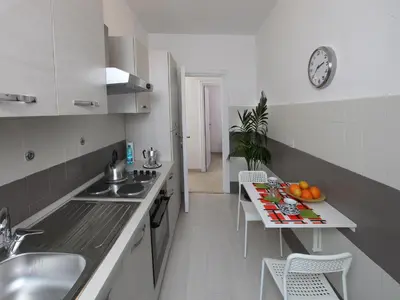a kitchen with a sink and a table with fruit on it at Marina Home in Rome