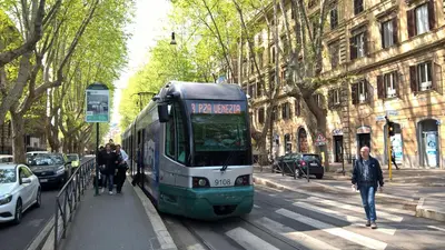 a bus on a city street with people walking next to it at Capital Flat 9/b in Rome