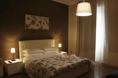 a bedroom with a bed with two tables and two lamps at Capital flat 9-A in Rome