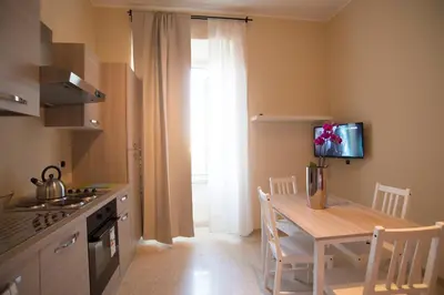 a kitchen with a table and a dining room at Capital flat 9-A in Rome