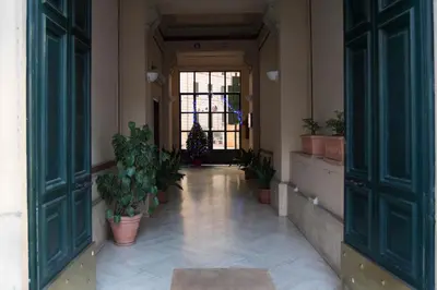 an empty hallway with potted plants in a building at Capital flat 9-A in Rome