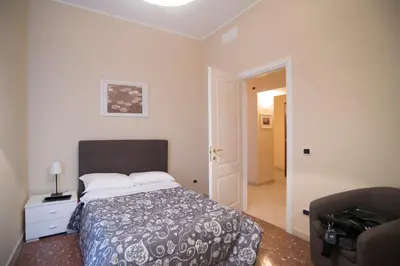 a bedroom with a bed and a door to a hallway at Capital flat 9-A in Rome