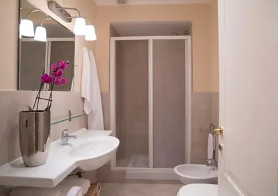 a bathroom with a toilet and a sink and a shower at Capital flat 9-A in Rome