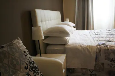 a bedroom with a bed with a pile of pillows at Capital flat 9-A in Rome