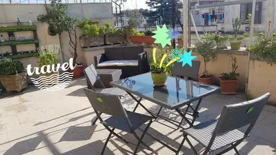 a table and chairs on a patio with plants at Robta's Dream Home in Rome
