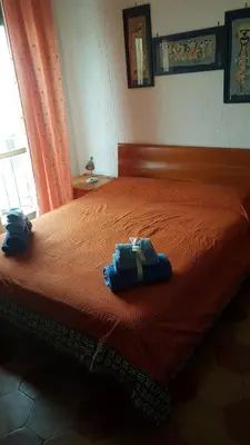 a bedroom with a bed with two towels on it at Robta's Dream Home in Rome