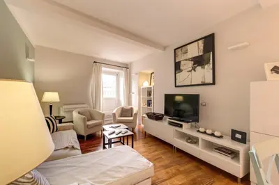 a living room with a couch and a tv at Appartamento con vista sul Vittoriano in Rome
