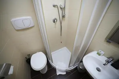 a bathroom with a shower and a toilet and a sink at KayDee GuestHouse in Rome
